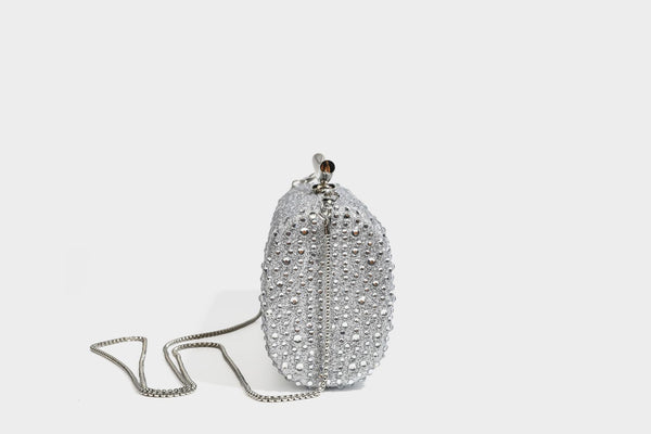 Structured rectangular hard-case clutch bag covered in all-over rhinestone crystal embellishment with curved kiss-lock top
