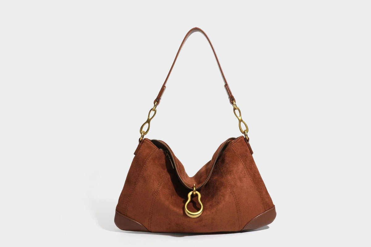 Slouchy denim shoulder bag with dark leather-look trim, gold-tone chain-link hardware, and top zipper closure, detail view 22
