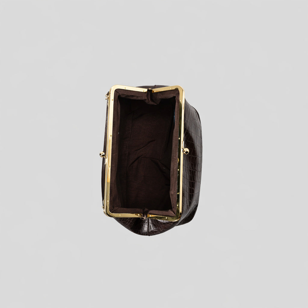 Trapezoid kiss-lock frame shoulder bag with gold-tone hardware and slim adjustable strap, detail view 4