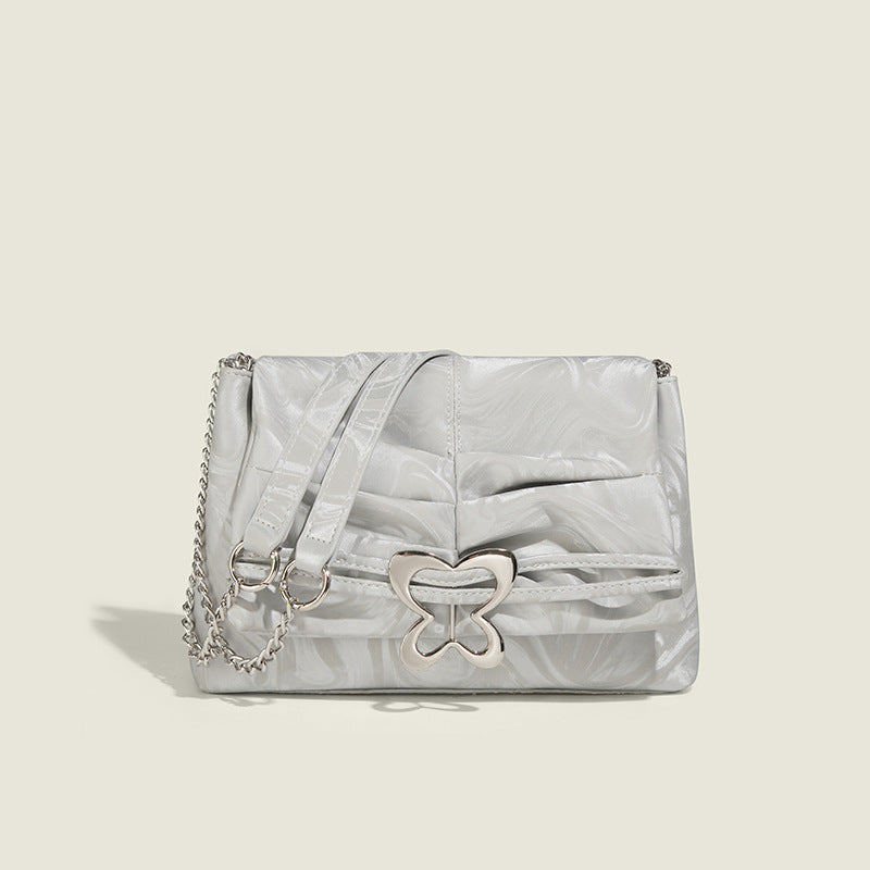 Structured rectangular chain shoulder bag with silver butterfly clasp and glossy crinkled finish, detail view 8
