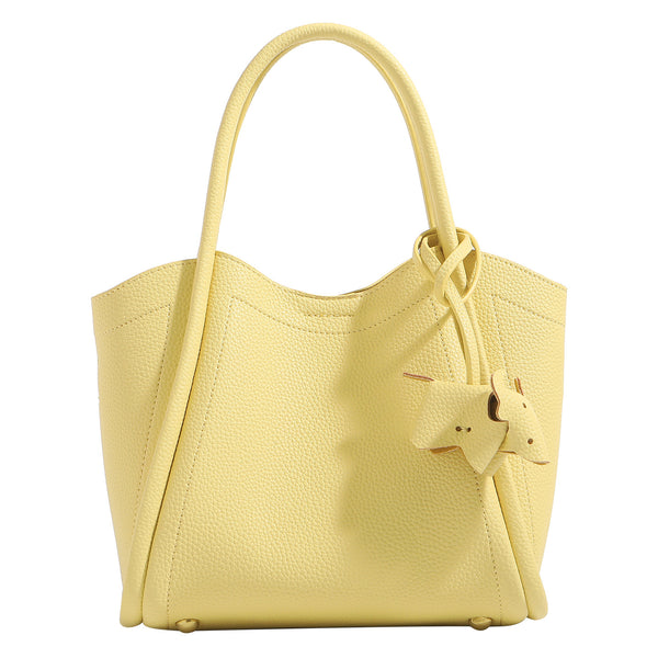 Small structured pebbled leather-look bucket tote bag with bow charm tie closure and gold-tone hardware, detail view 5