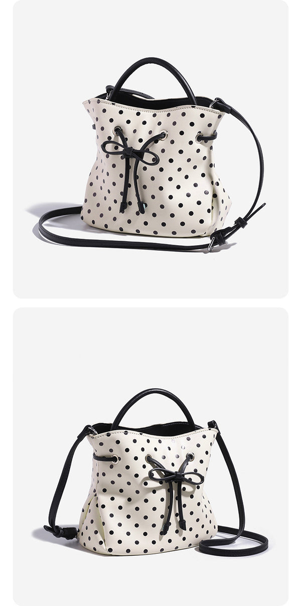 Compact polka-dot drawstring bucket bag with bow closure and rigid top handle, detail view 8