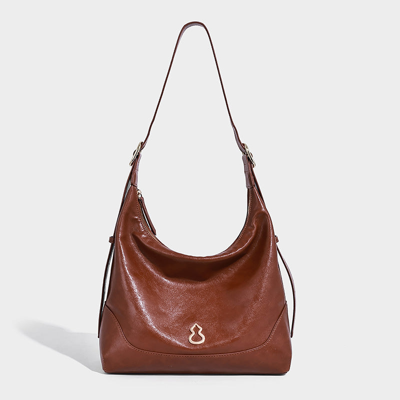 Glossy leather-look slouchy hobo shoulder bag with zip closure, gold-tone hardware, and adjustable strap, detail view 6