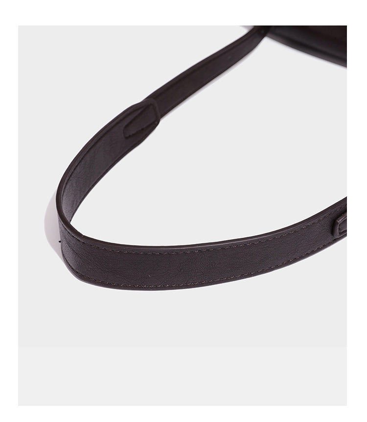 Structured rectangular flap shoulder bag in dark brown leather-look finish with long single strap and layered front panel