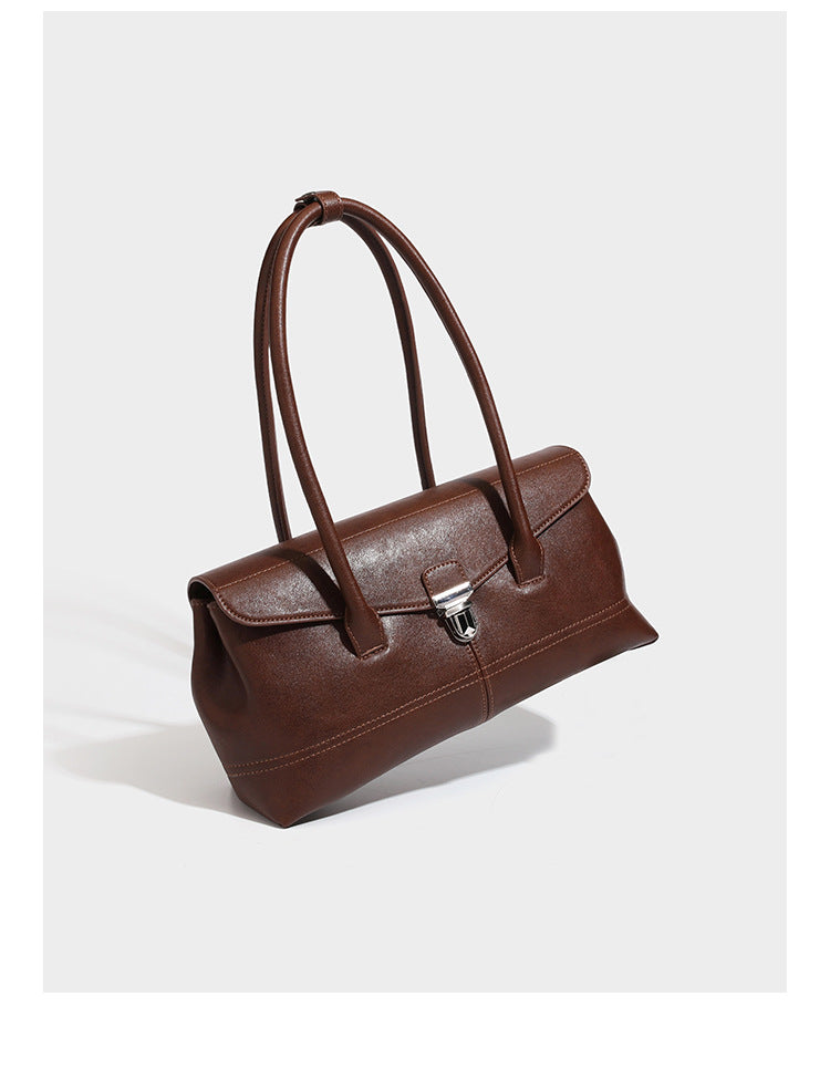 Structured rectangular satchel bag with dual rounded top handles and central metal turn-lock flap closure, detail view 7