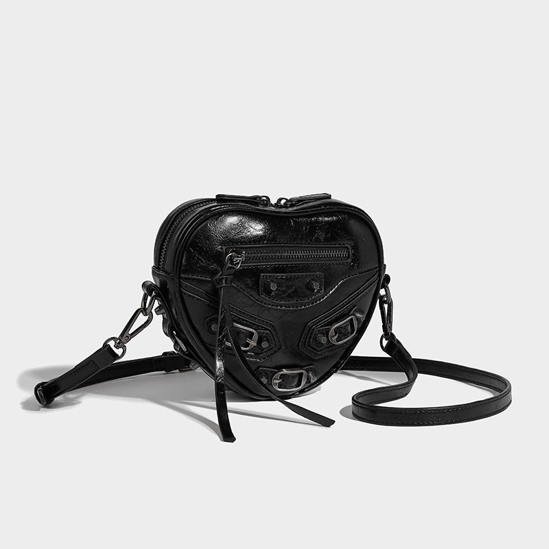 Mini heart-shaped crossbody bag with glossy crinkled finish and moto buckle hardware, detail view 20