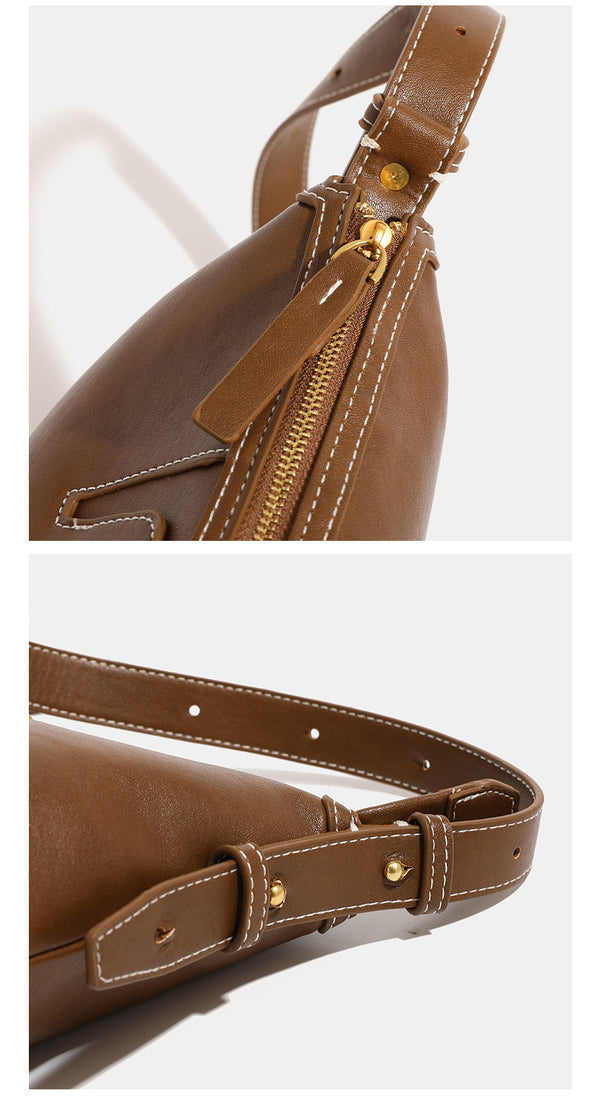 Smooth leather-look hobo bag with gold-tone ring hardware, contrast stitching, top handle and adjustable crossbody strap
