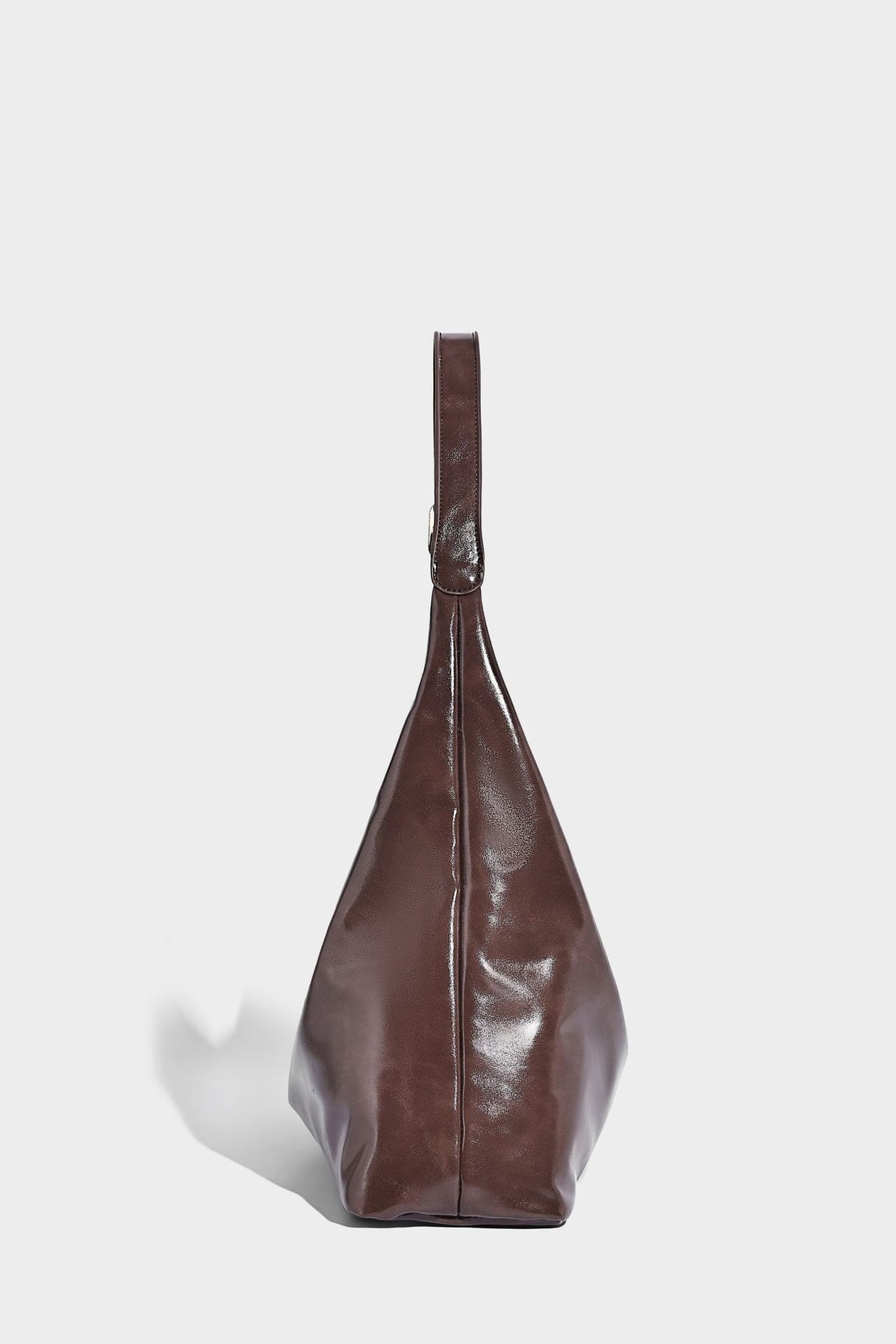 Glossy slouchy hobo shoulder bag with adjustable strap and embossed floral emblem, detail view 19