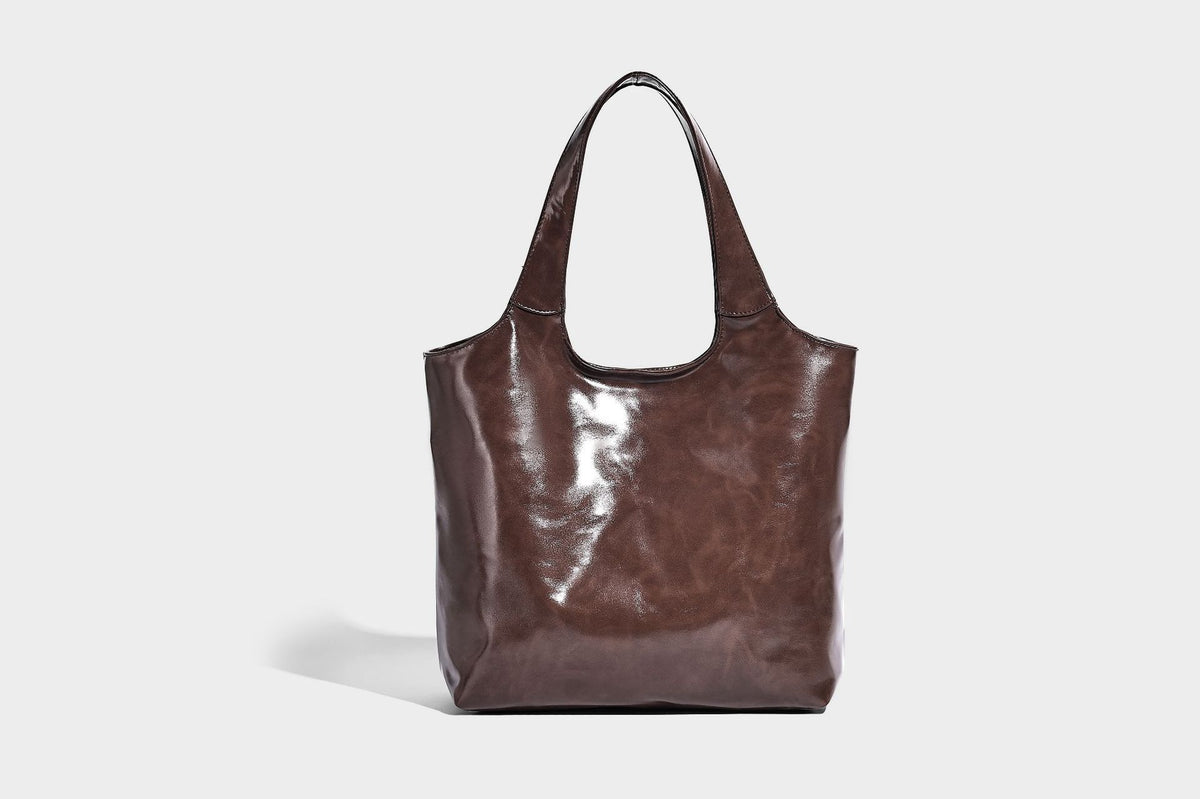 Glossy oil-wax leather-look open-top tote shoulder bag with embossed circular logo and long double straps, detail view 26