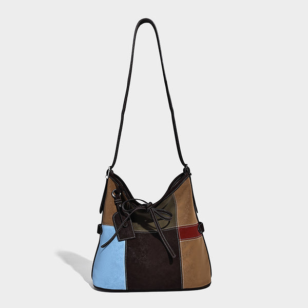 Patchwork bucket tote shoulder bag with tan, dark brown, olive, red, and sky blue color-block panels, white contrast, detail