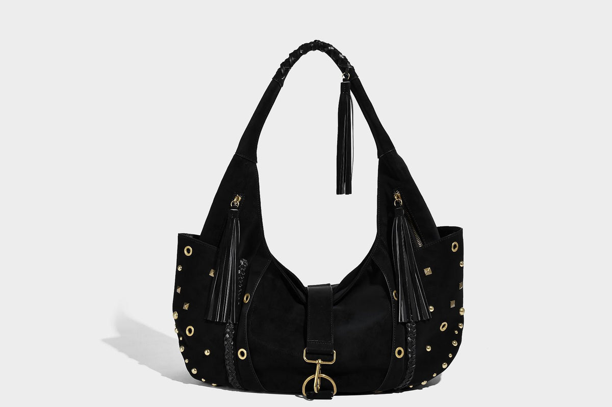 Slouchy crescent hobo bag in matte brown suede-like finish with gold-tone studs, grommets, braided top handle, tassel side