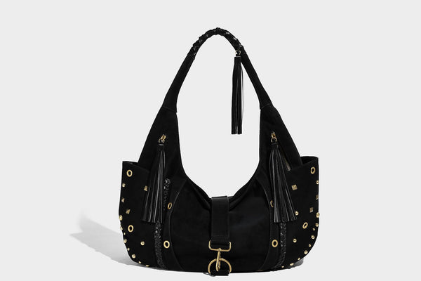 Slouchy crescent hobo bag in matte brown suede-like finish with gold-tone studs, grommets, braided top handle, tassel side