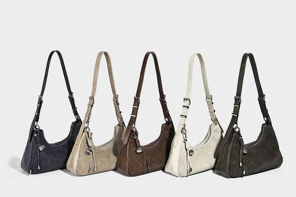 Woven crescent hobo shoulder bag with smooth side panels, zip-top closure, silver-tone charm hardware, and adjustable, detail