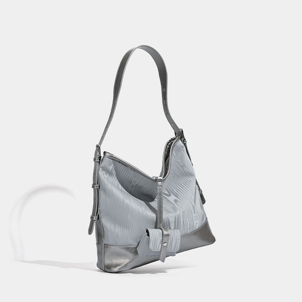 Silbergraue, weich fallende Hobo-Schultertasche mit holzmaserungsgeprägten Einsätzen, glänzenden Metallic-Details, Reißverschluss oben und vorderer Klappe