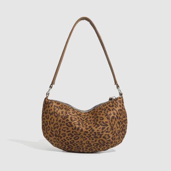 Brown and tan leopard print crescent hobo shoulder bag with zip top closure, front zip pocket, and adjustable silver-tone