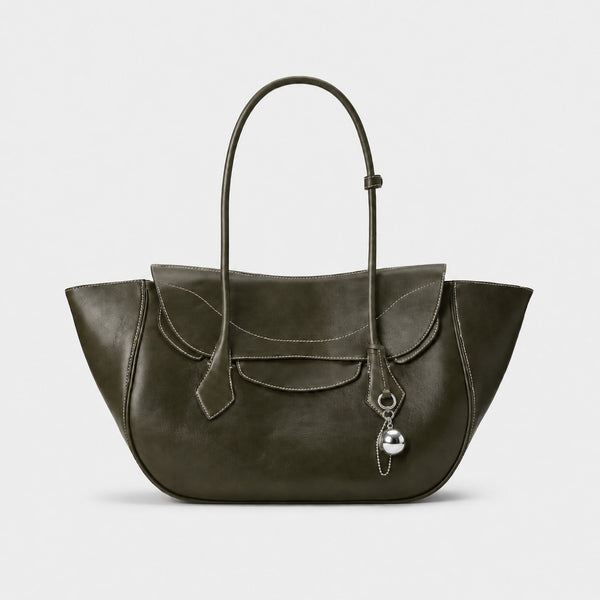 Large winged leather-look tote bag with single arched handle, stitched flap-front panel, and silver ball charm in cognac