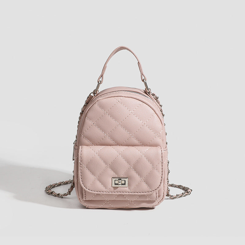 Compact diamond-quilted mini backpack handbag with silver-tone chain straps and turn-lock front pocket, detail view 6