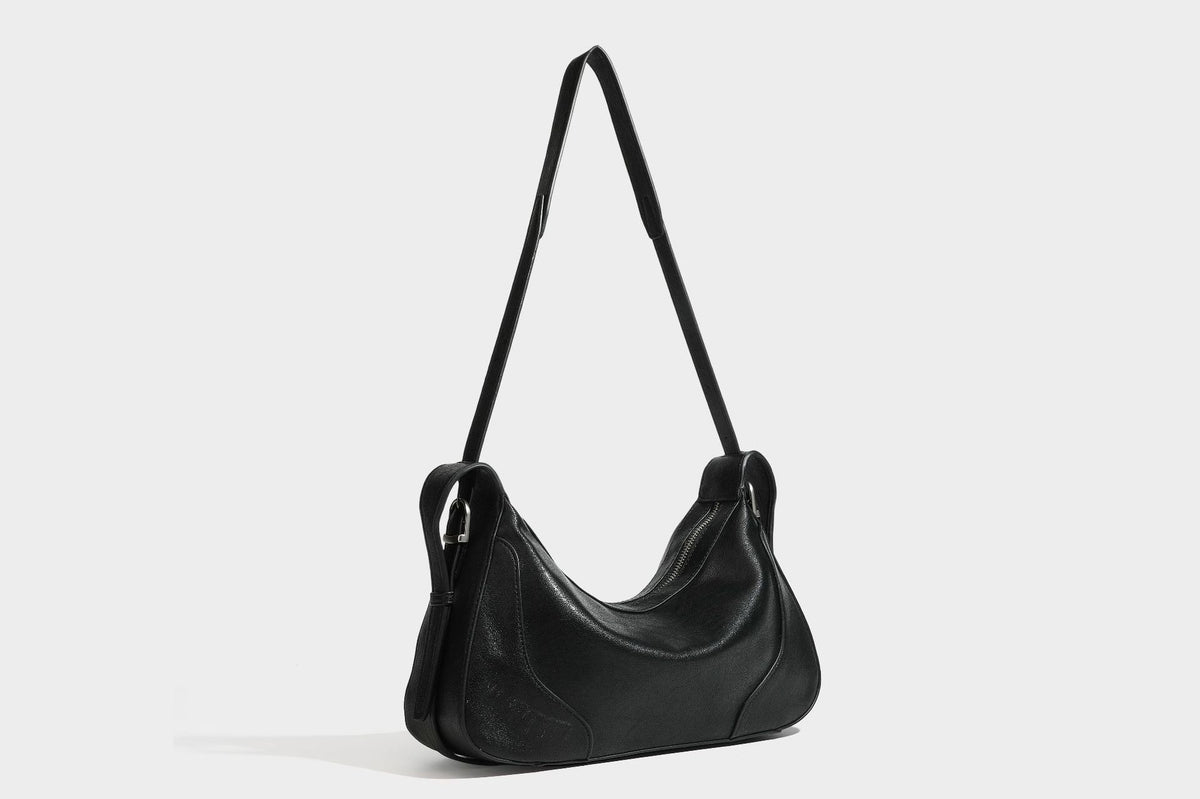 Slouchy crescent hobo shoulder bag in dark brown pebbled leather-look finish with zip top and long shoulder strap, detail