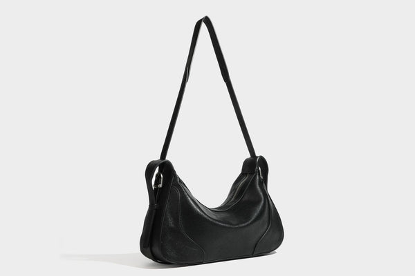 Slouchy crescent hobo shoulder bag in dark brown pebbled leather-look finish with zip top and long shoulder strap, detail