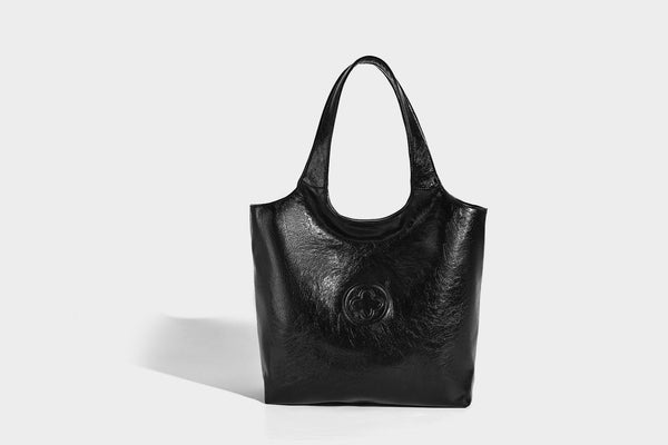 Glossy oil-wax leather-look open-top tote shoulder bag with embossed circular logo and long double straps, detail view 15