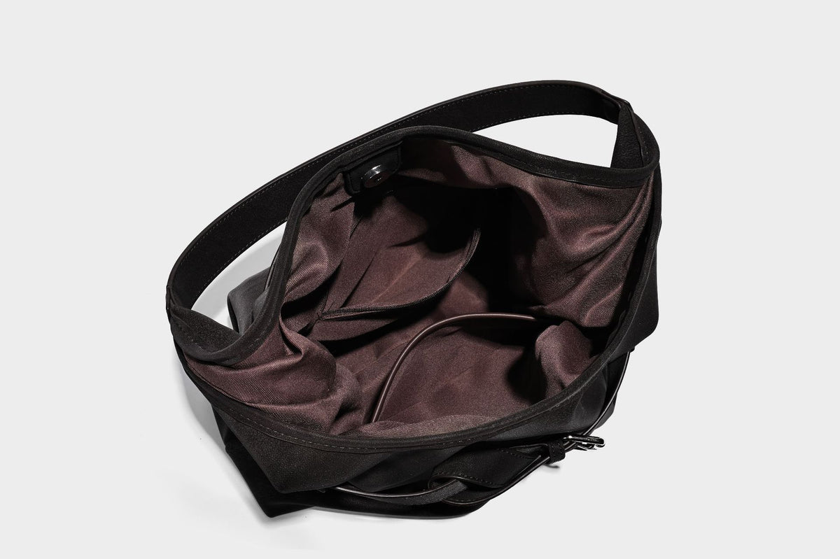 Slouchy oversized shoulder tote bag with matte textured finish, wrap-around buckle strap, and detachable front zip pouch