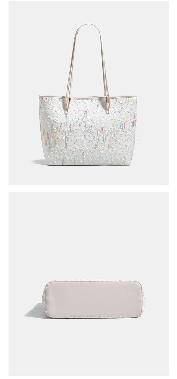 Off-white structured tote bag with dual shoulder straps, gold-tone hardware, and plush bear charm, detail view 12
