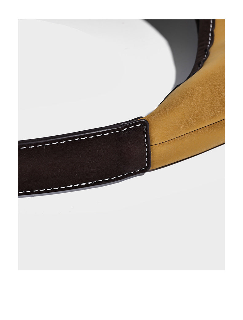 Multicolor patchwork hobo shoulder bag with brown tan olive mustard red and blue suede-look panels, contrast white stitching