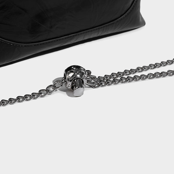 Glossy crinkled ruched drawstring bucket bag with rounded double top handles and detachable chain crossbody strap, detail