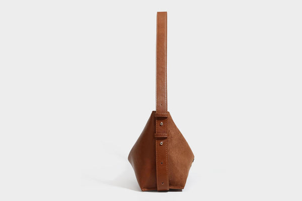 Slouchy suede-finish brown shoulder bag with long single strap and small gold-tone logo emblem on front, detail view 25