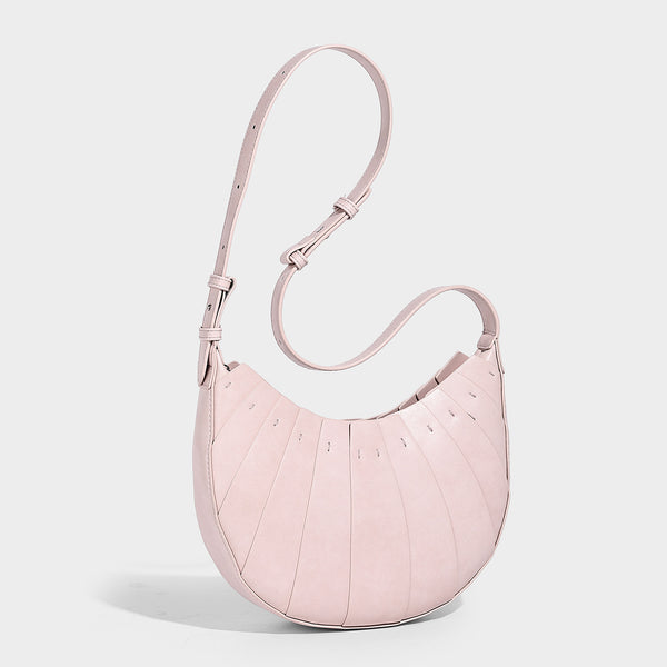 Crescent half-moon shoulder bag with vertical panel seaming, matte-satin leather-look finish, and adjustable gold-tone
