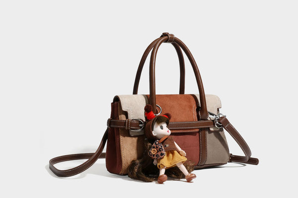 Structured color-block satchel bag in brown, rust, beige, and taupe suede-look panels with white topstitching, front buckle