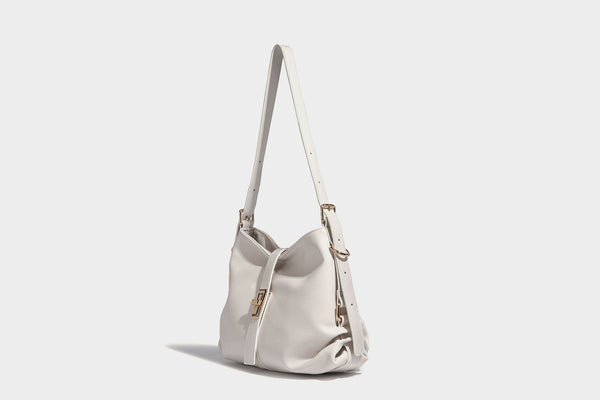 Soft slouchy hobo shoulder bag with smooth leather-look finish, gold-tone buckle and tab hardware, and long adjustable strap