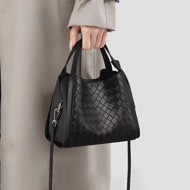 Black woven leather-look bucket tote bag with dual top handles and detachable shoulder strap, silver-tone hardware and zip