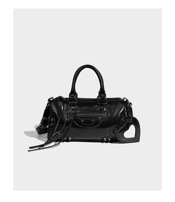 Glossy studded mini satchel bag with braided top handles, front zip pocket, heart charm, and detachable crossbody strap