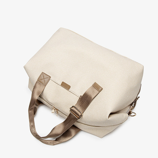 Structured woven duffel bag with dual tan webbing handles, detachable shoulder strap, top zip closure, and gold-tone