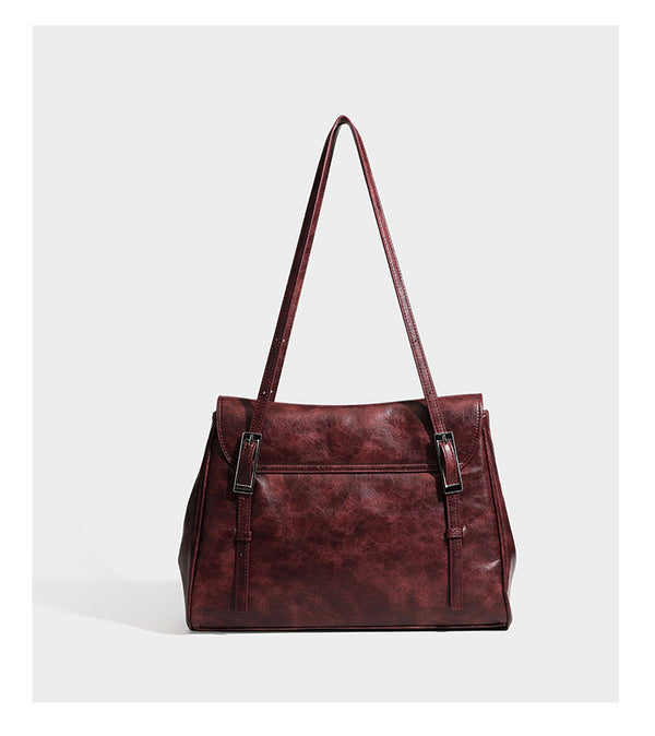 Structured flap-top shoulder tote bag in distressed leather-look finish with silver-tone buckle hardware and double shoulder