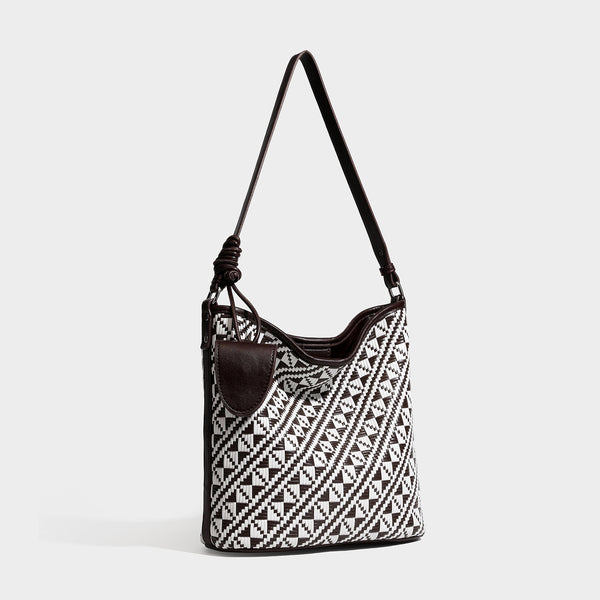 Geometrisch gemusterte Schultertasche mit gewebtem Ethno-Muster, dunkelbrauner Lederoptik-Besatzung, langem verstellbarem Riemen und kleinem herabhängendem Reißverschluss