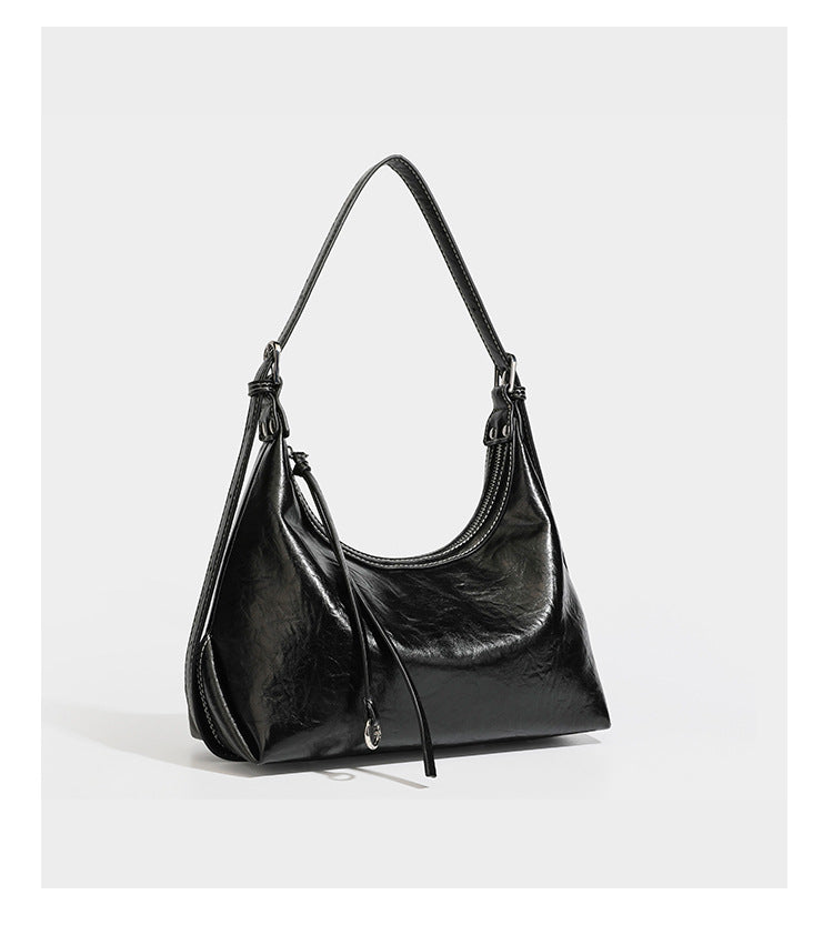 Slouchy hobo shoulder bag in glossy crinkled leather-look finish with zip-top closure and silver-tone ring hardware, detail