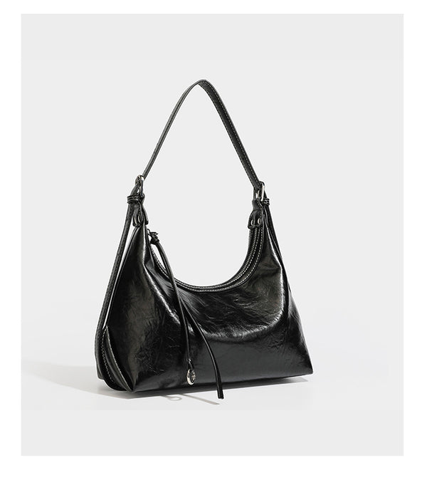 Slouchy hobo shoulder bag in glossy crinkled leather-look finish with zip-top closure and silver-tone ring hardware, detail
