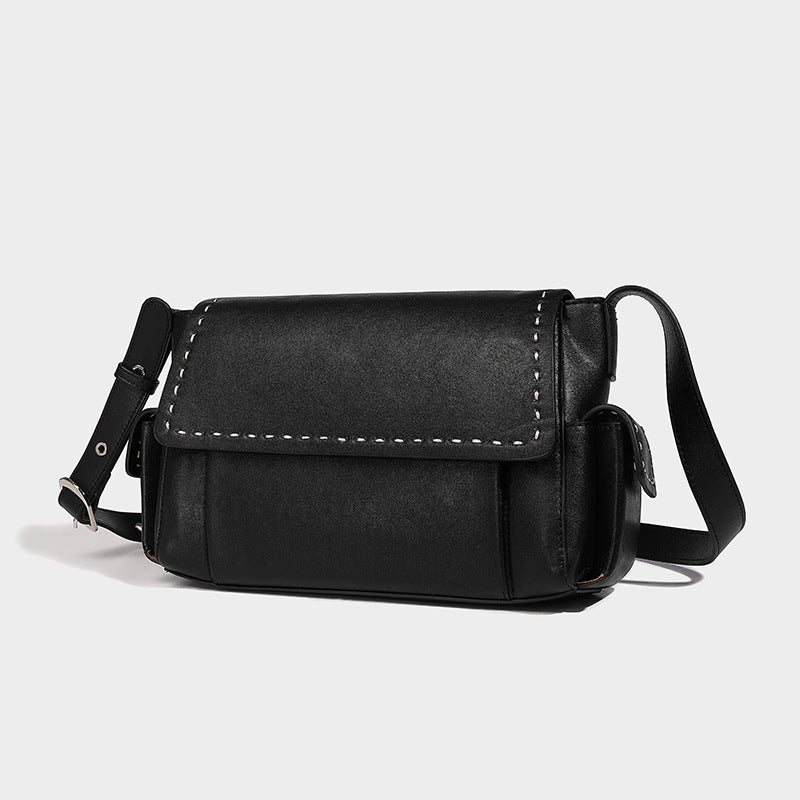 Structured flap crossbody bag in dark brown and cream color-block with white contrast stitching, adjustable shoulder strap
