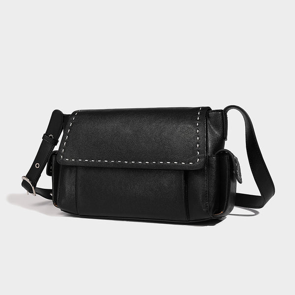 Structured flap crossbody bag in dark brown and cream color-block with white contrast stitching, adjustable shoulder strap