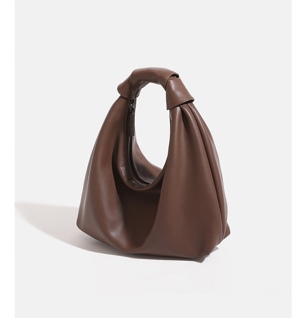 Slouchy leather-look hobo bag with knotted loop handle and top zipper closure, detail view 10