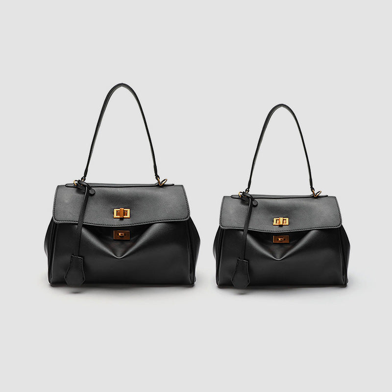 Structured black leather-look flap satchel bag with silver turn-lock hardware and top handle, detail view 2
