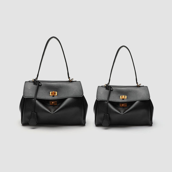 Structured black leather-look flap satchel bag with silver turn-lock hardware and top handle, detail view 2