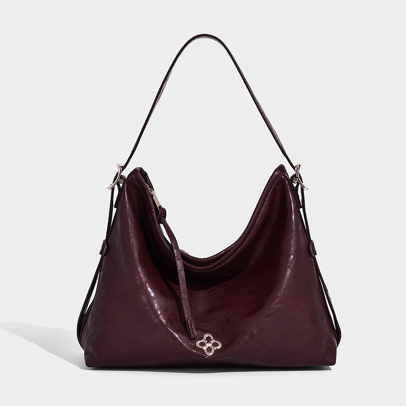Slouchy leather-look hobo shoulder bag with gold-tone hardware and adjustable strap in brown, detail view 16