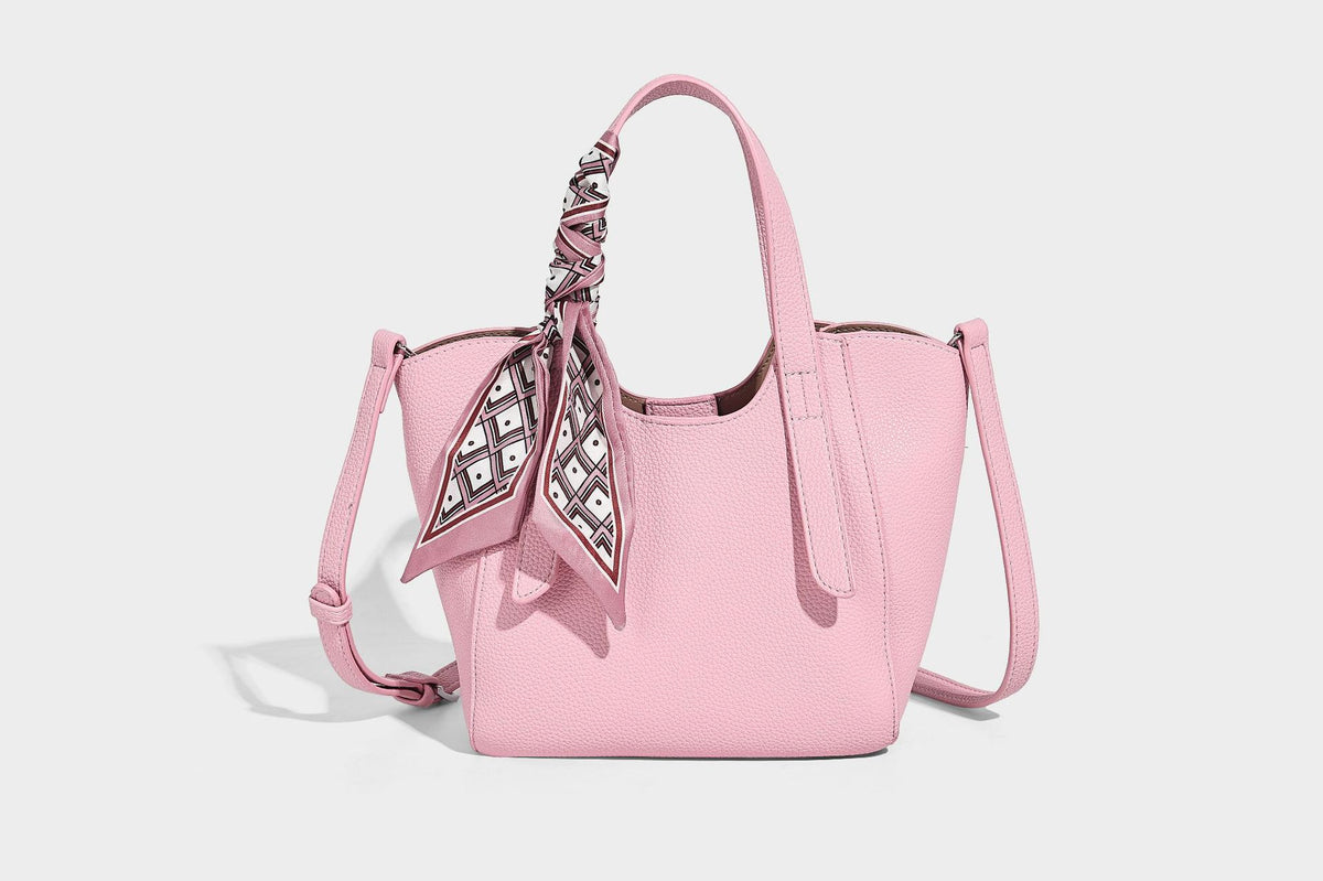 Structured pebbled leather-look tote bag with detachable scarf tie, dual top handles, and adjustable crossbody strap, detail