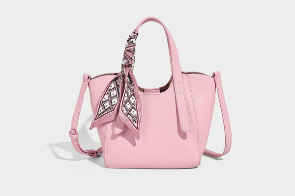 Structured pebbled leather-look tote bag with detachable scarf tie, dual top handles, and adjustable crossbody strap, detail