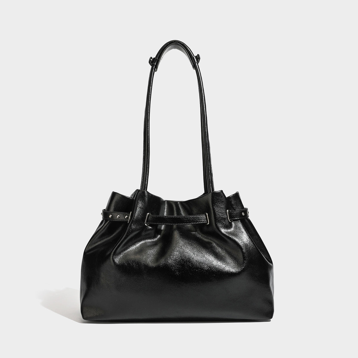 Glossy black slouchy shoulder bag with gathered top, twin long straps, silver-tone hardware, and detachable crossbody strap