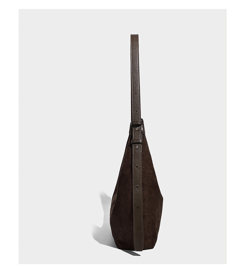 Slouchy crescent hobo shoulder bag in dark chocolate matte suede-look finish with adjustable strap and twin-pull top zip