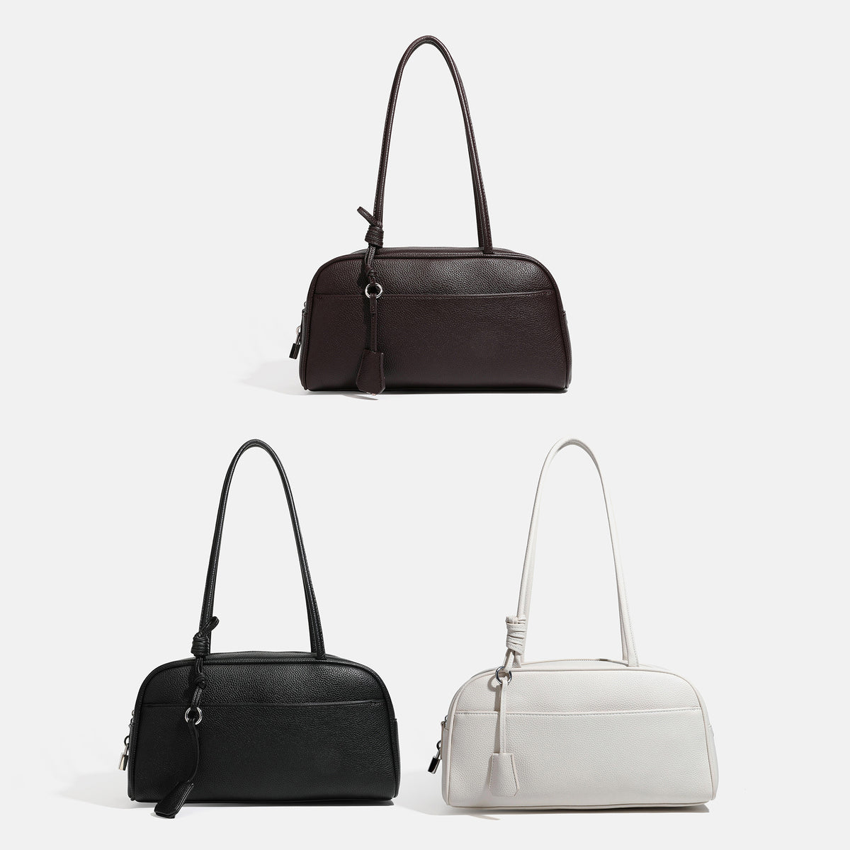 Structured rounded rectangular shoulder bag with pebbled leather-look finish, dual long handles, top zipper, front zip